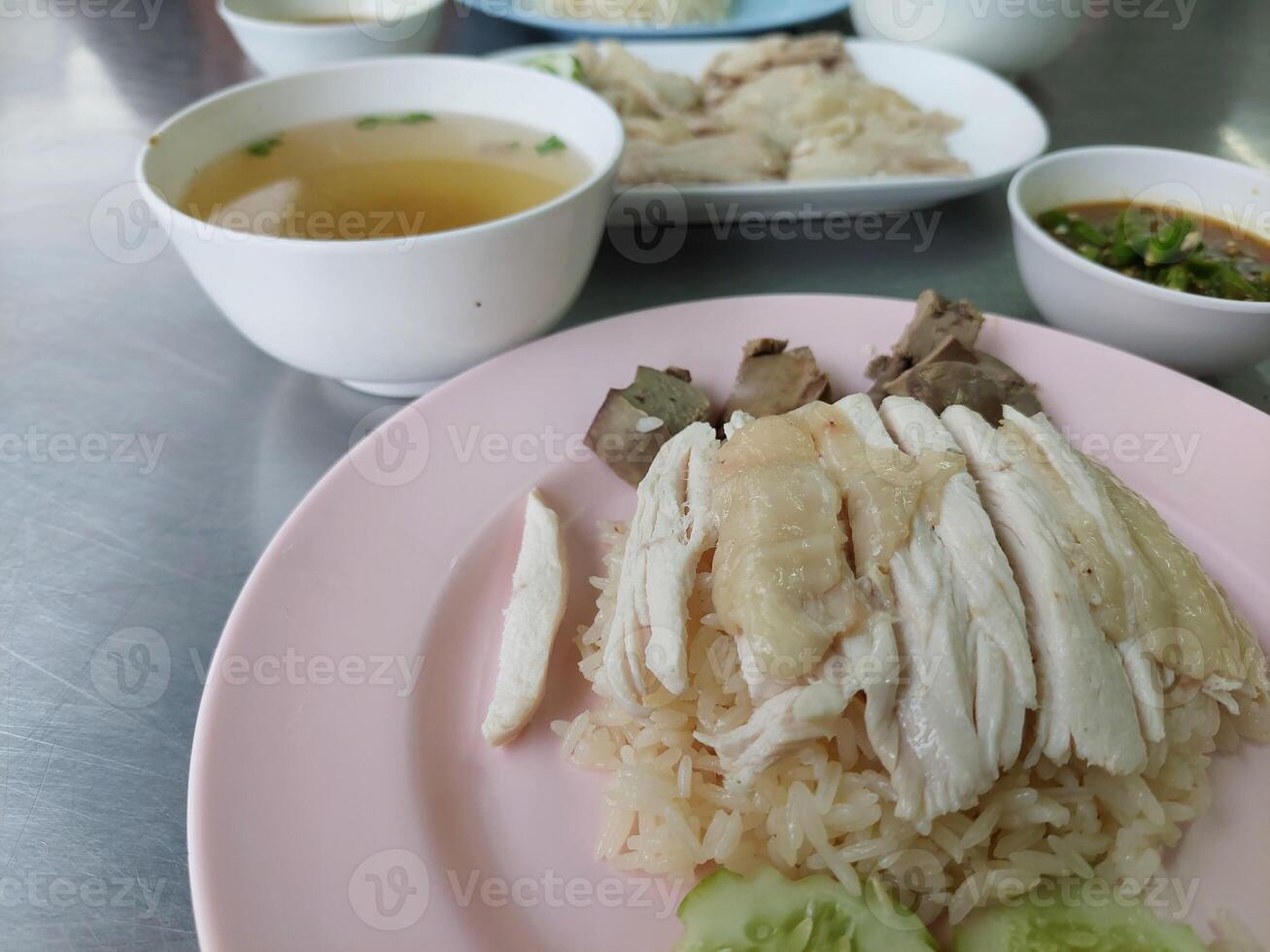 A pink plate topped with rice and chicken photo