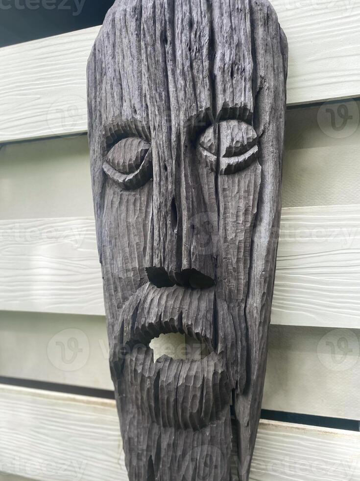 A wooden face mask with a beard and beard photo