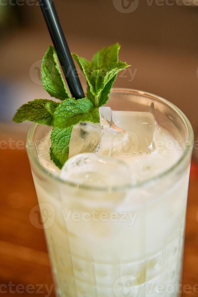 Refreshing minty lemonade with ice cubes in a glass photo