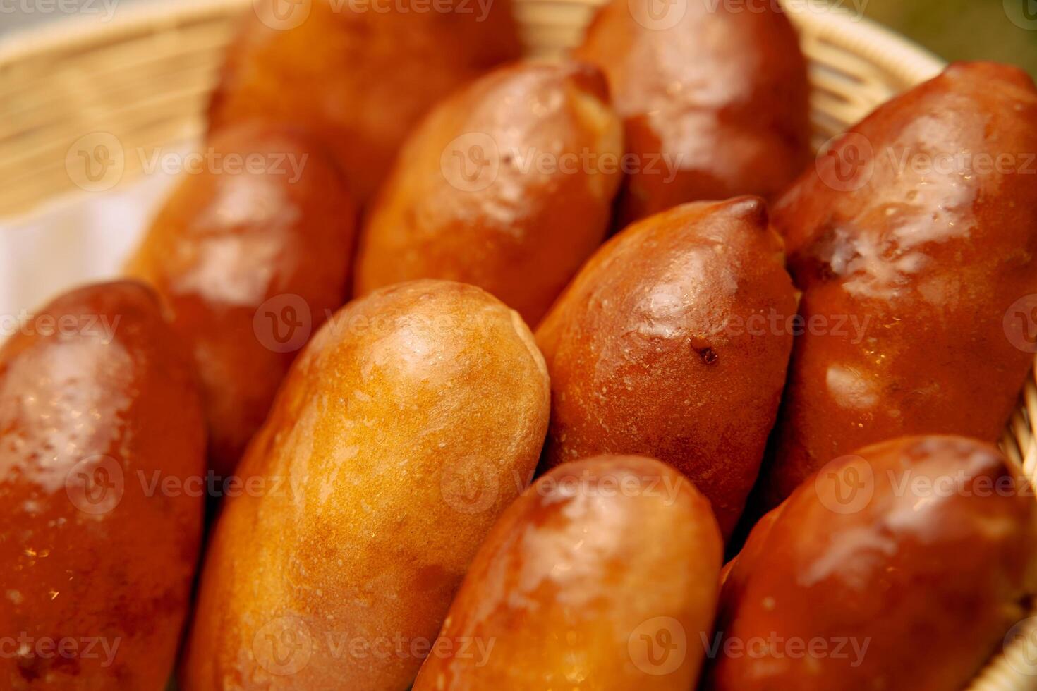 Freshly baked filipino bread pandesal rolls in brown basket photo