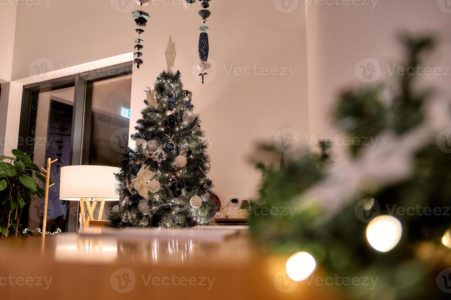 Elegant christmas tree in cozy living room with subtle decorations and soft lighting photo