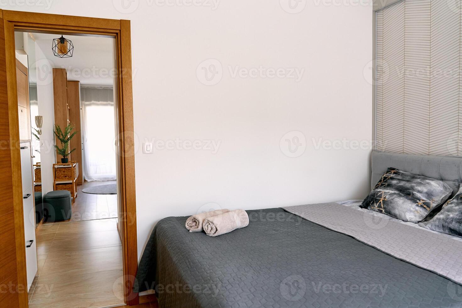 Cozy bedroom with modern decor and soft gray bedding in elegant apartment interior photo