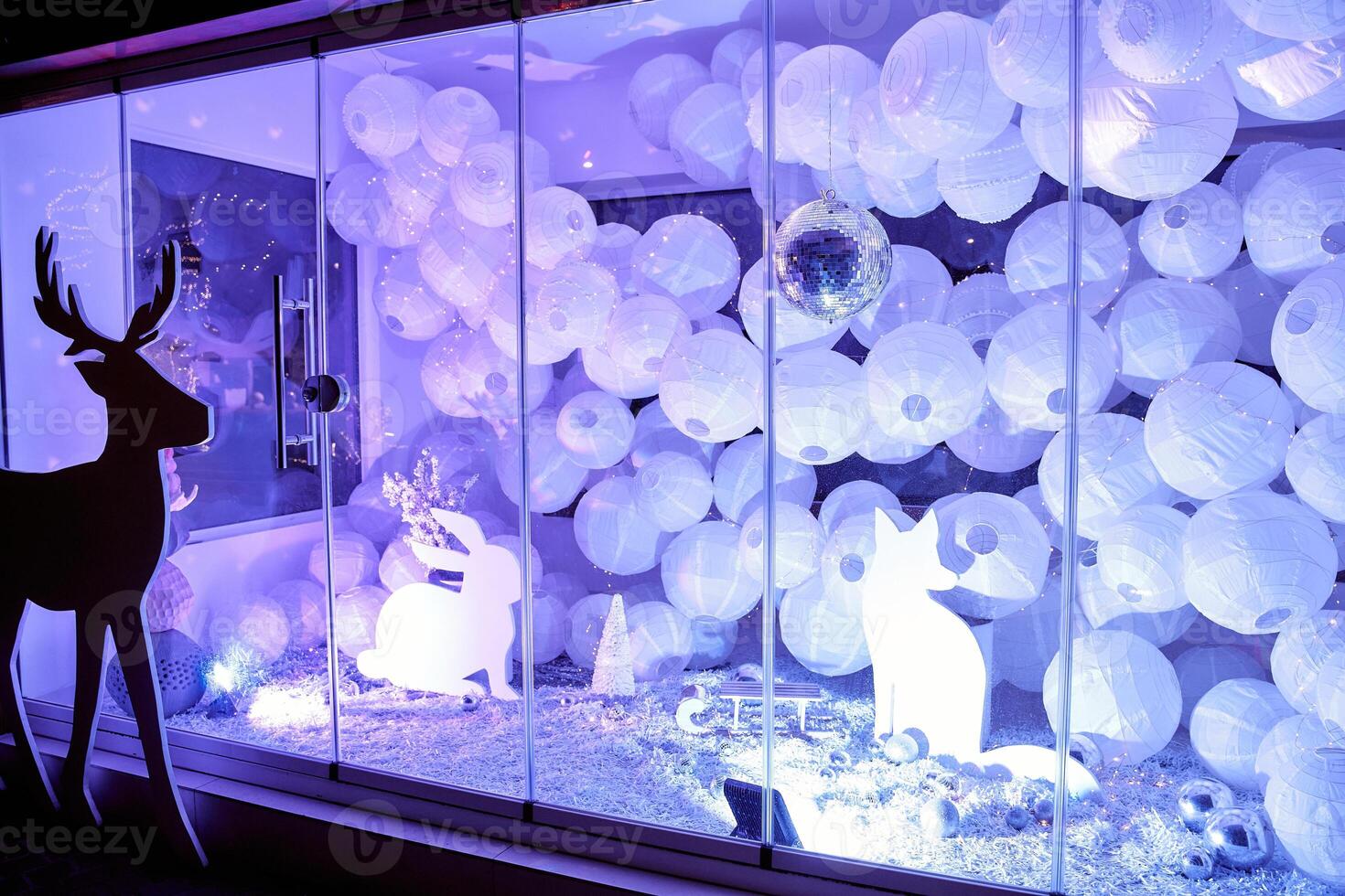 Magical winter wonderland display with reindeer silhouettes and festive lights photo
