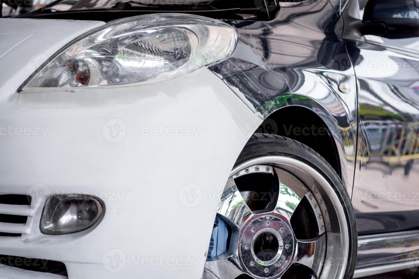 A close up of a white car with chrome wheels photo