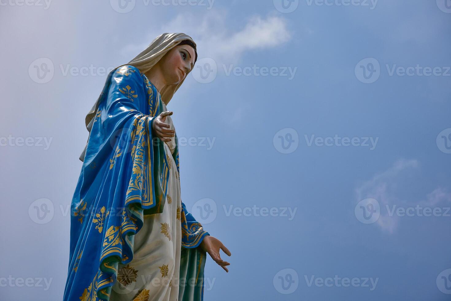 A statue of mary holding a baby in her arms photo