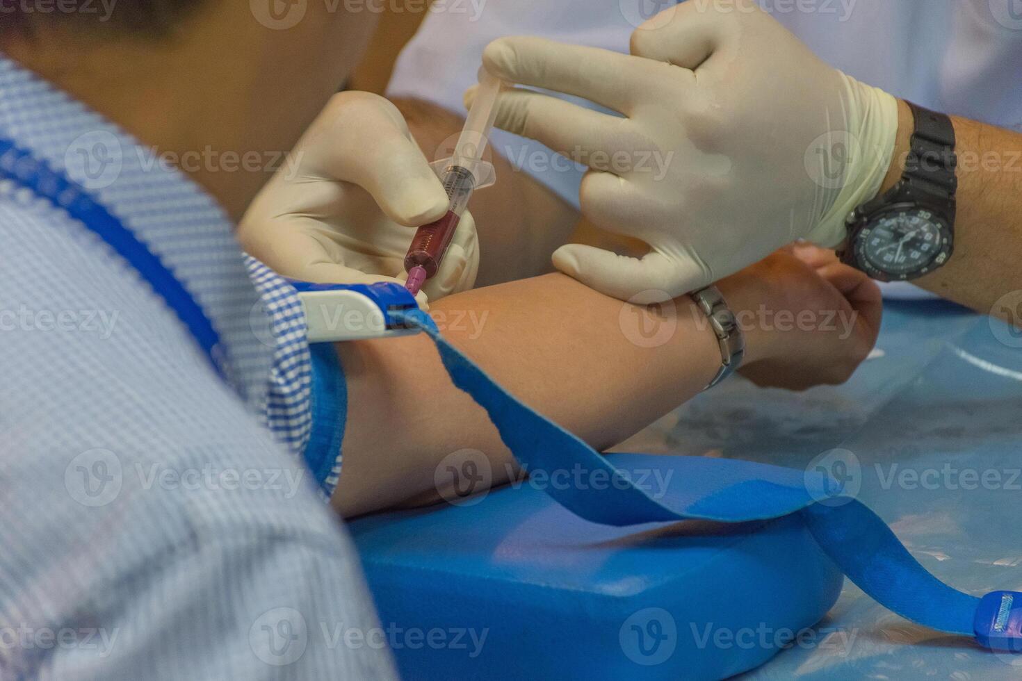 A person getting blood drawn by a doctor photo