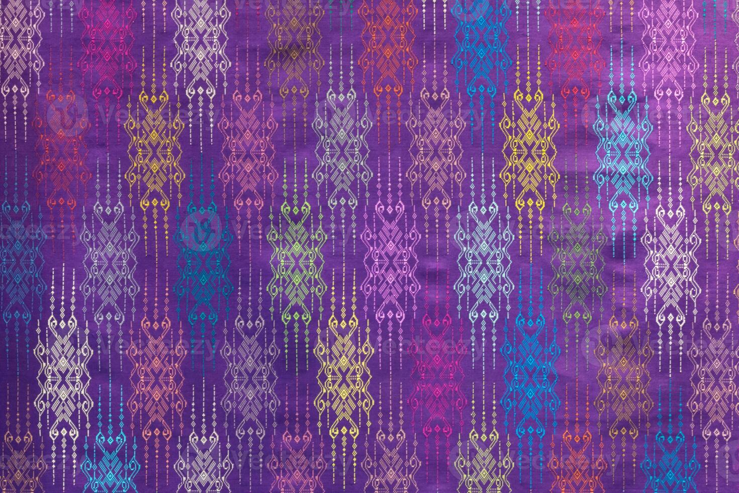 A purple and blue fabric with colorful designs photo