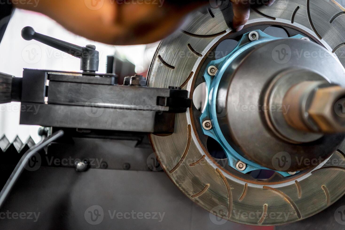 A person is working on a brake disc photo