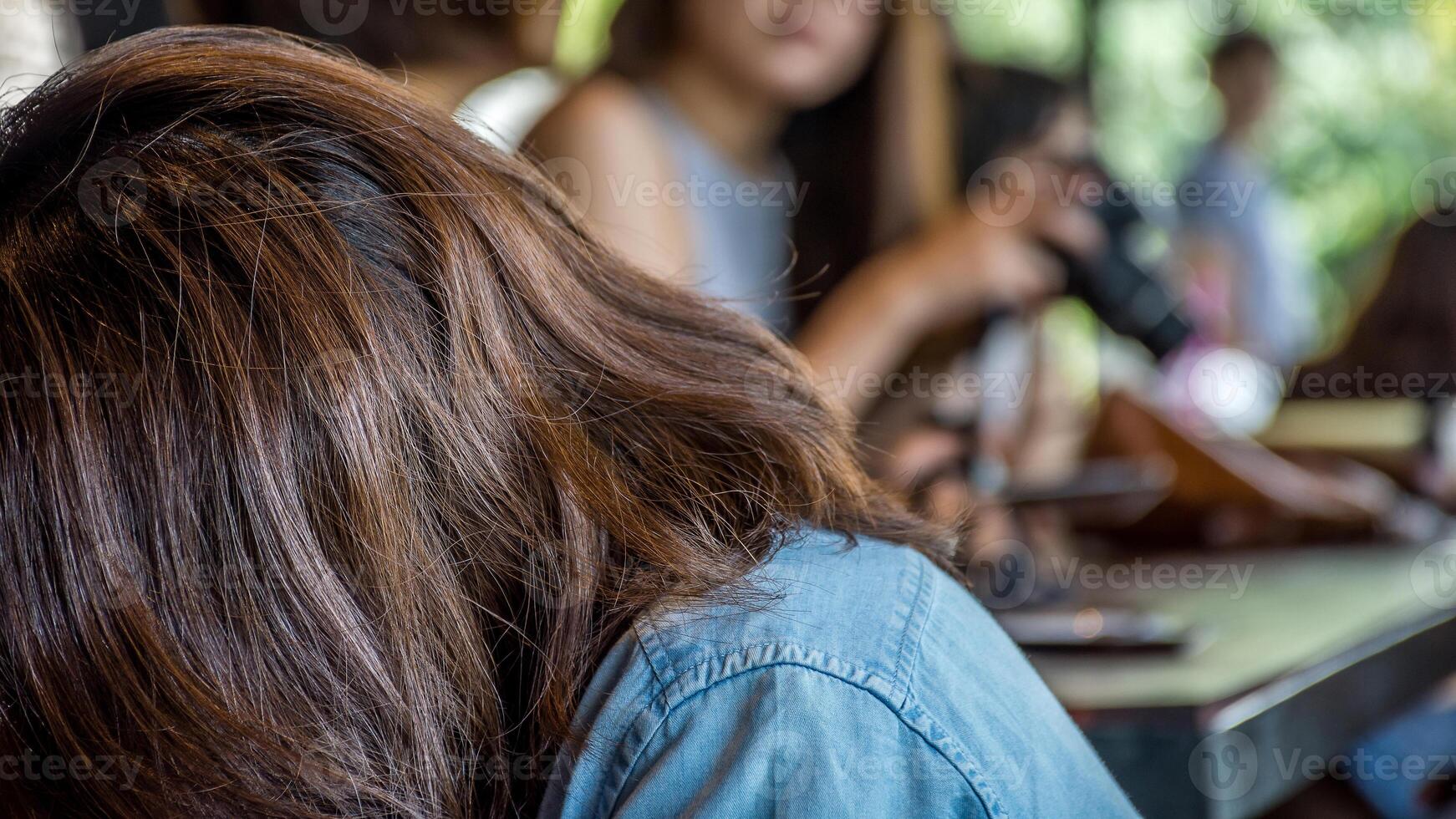 A woman with her head down on a table photo