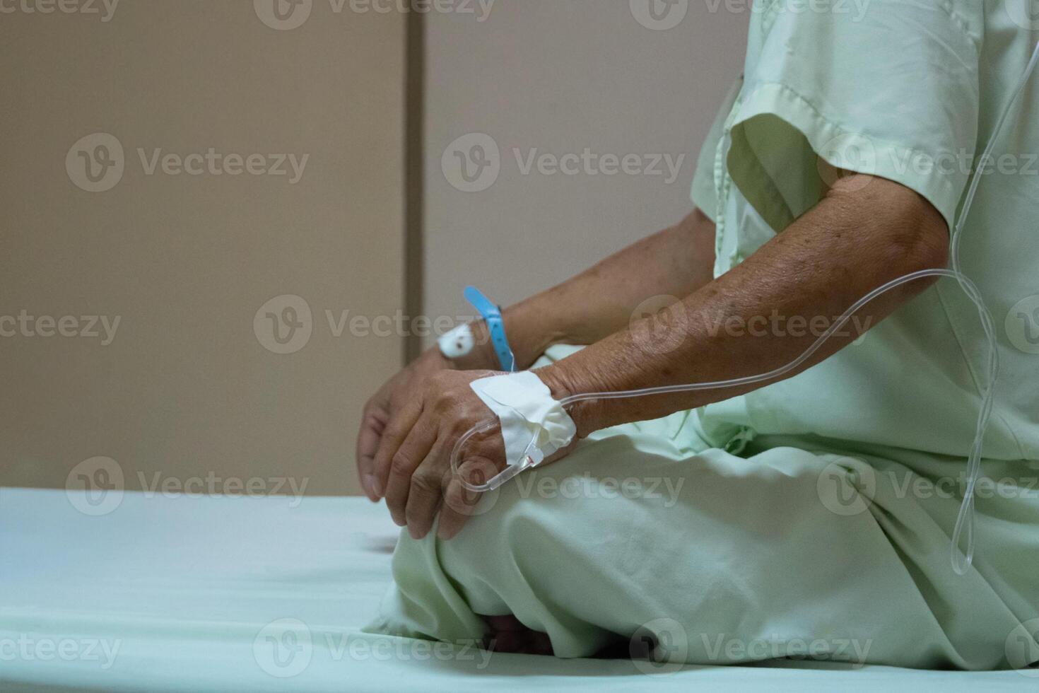 A man in a hospital bed with an iv photo