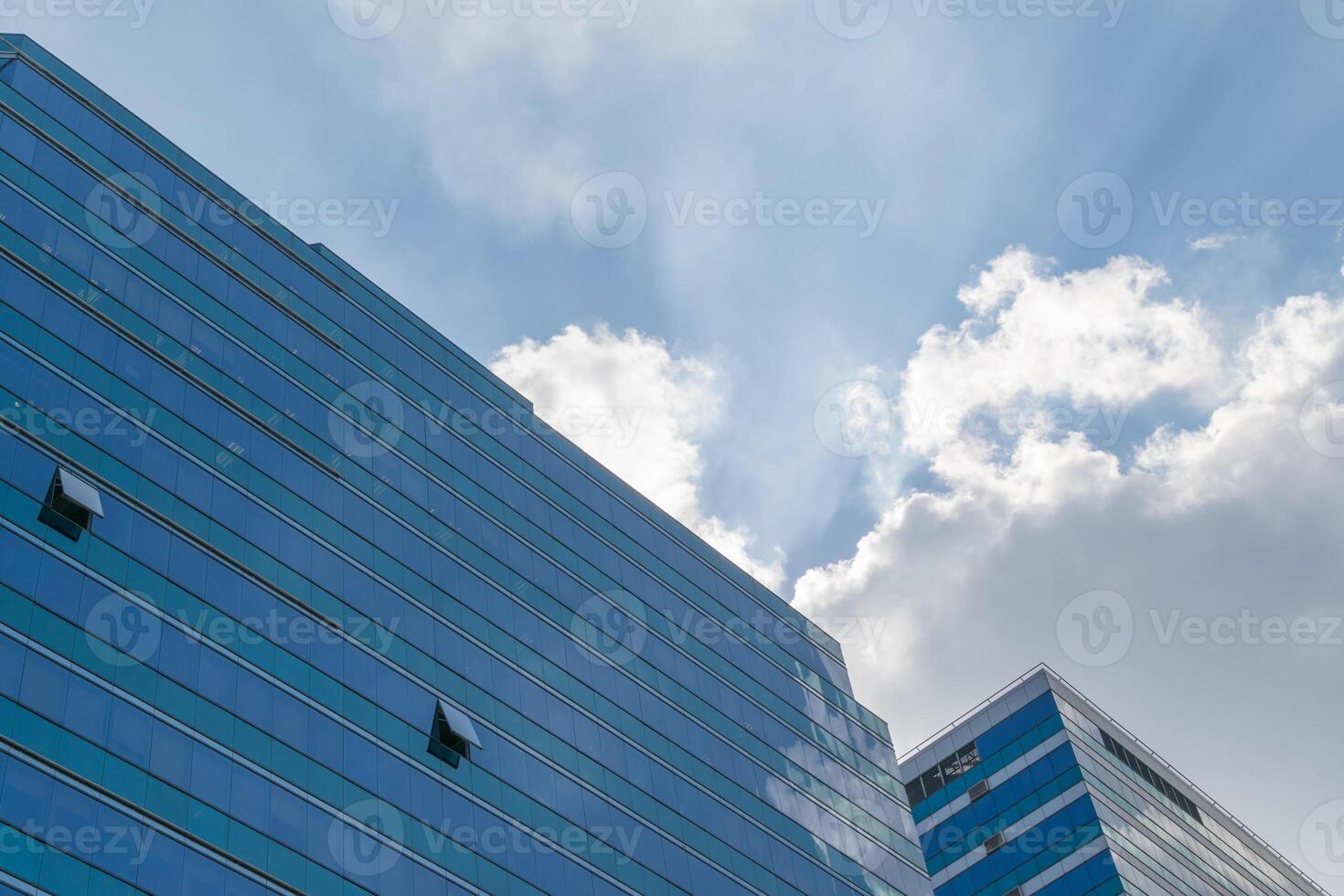 A blue building with a blue sky and clouds photo