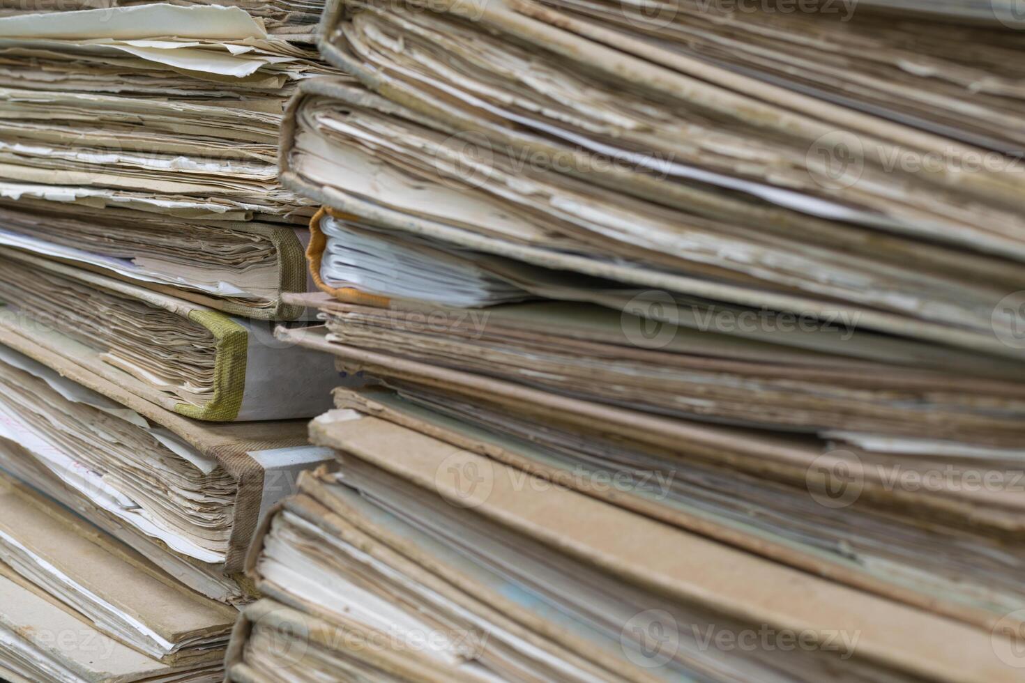 A pile of old documents sitting on top of each other photo