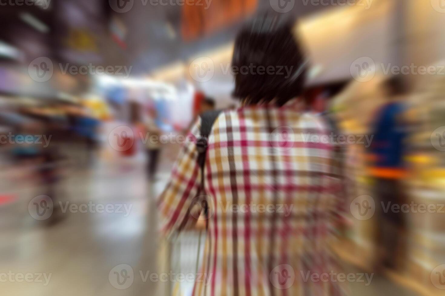 Blurry image of a woman walking down a shopping aisle photo