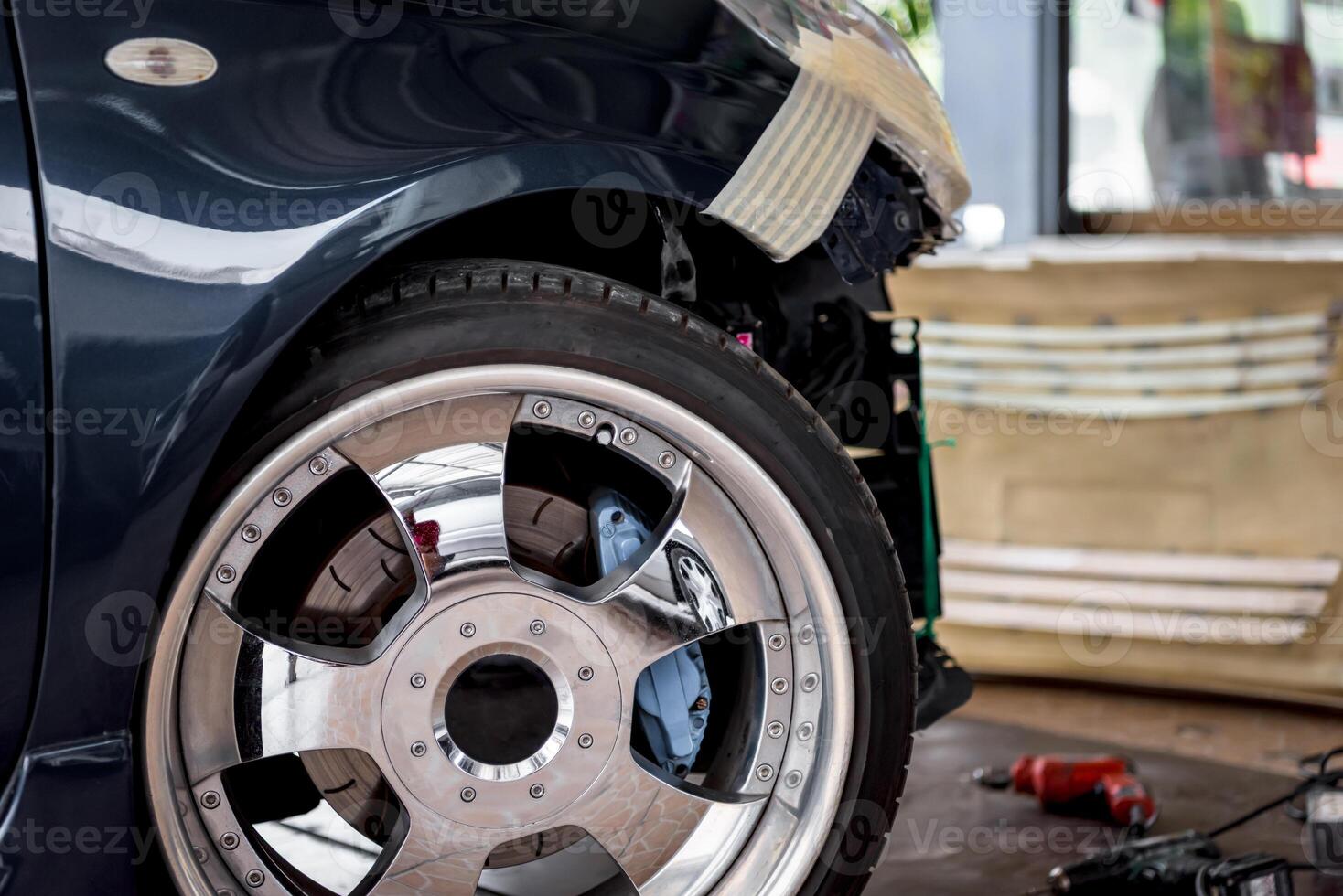 A car with a flat tire and a wheel photo
