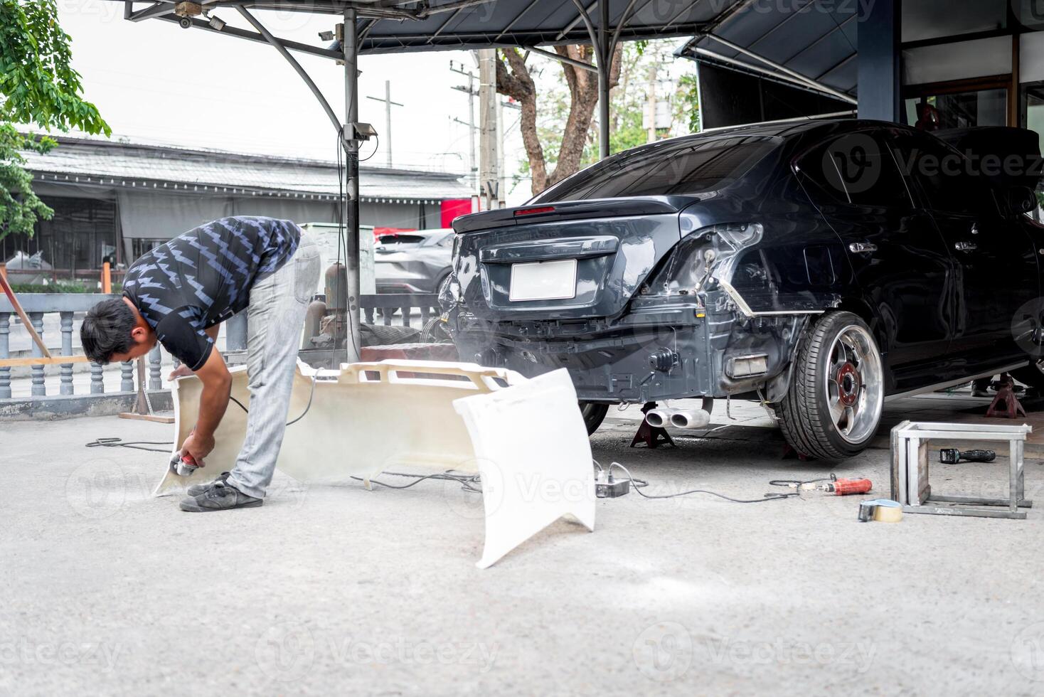 A man working on a car photo