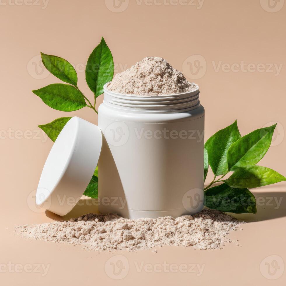 A jar of powder and a leaf on a beige background photo