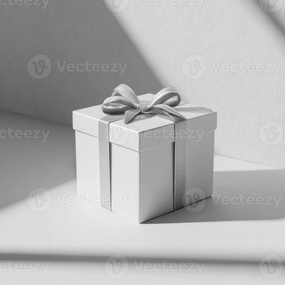 A white gift box with a ribbon on a table photo