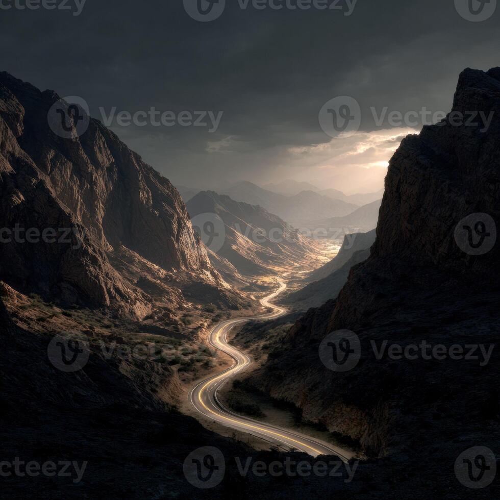 A winding road in the mountains with a dark sky photo