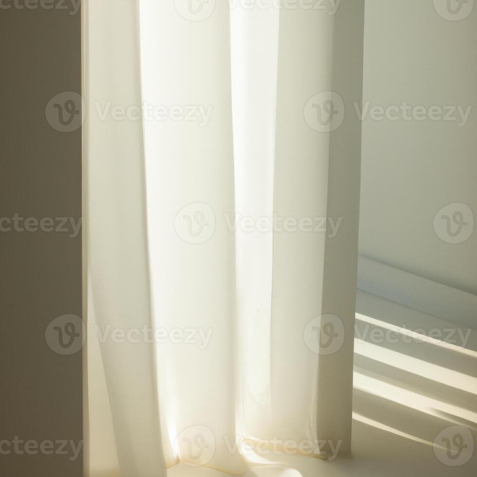 A white curtain is sitting in front of a window photo