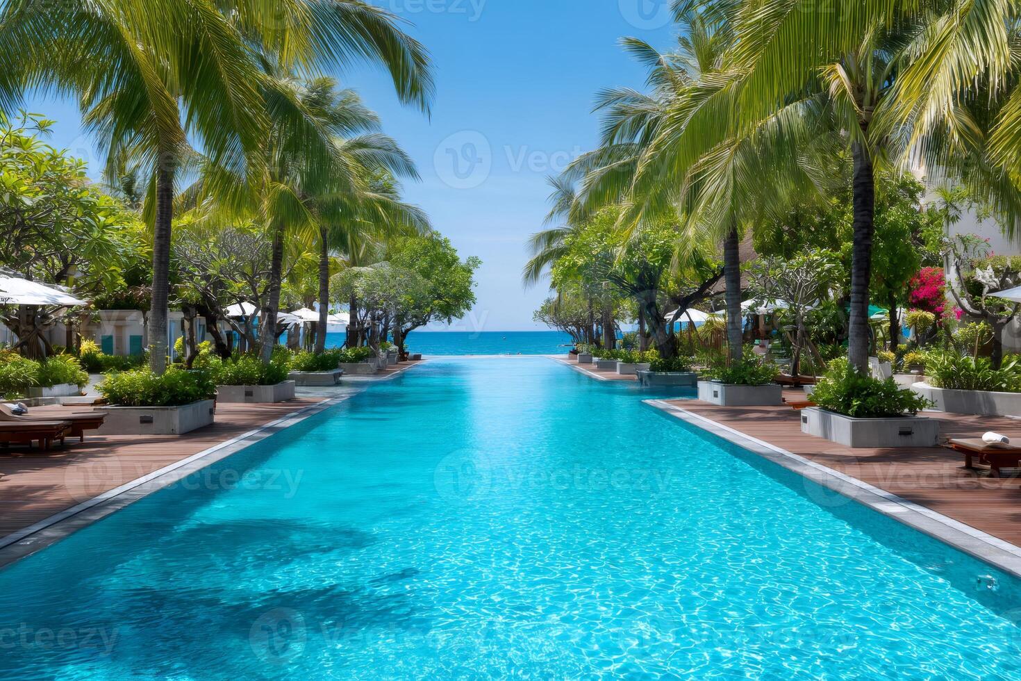 Infinity pool extending towards the ocean in tropical resort photo