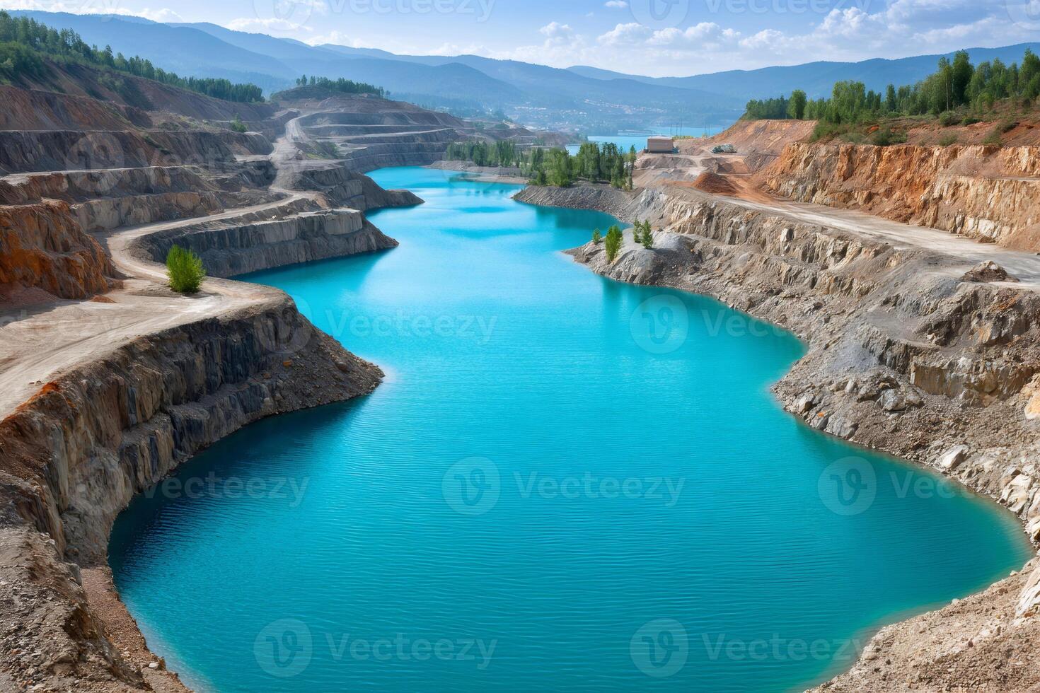 Turquoise water filling abandoned quarry in mountainous landscape photo