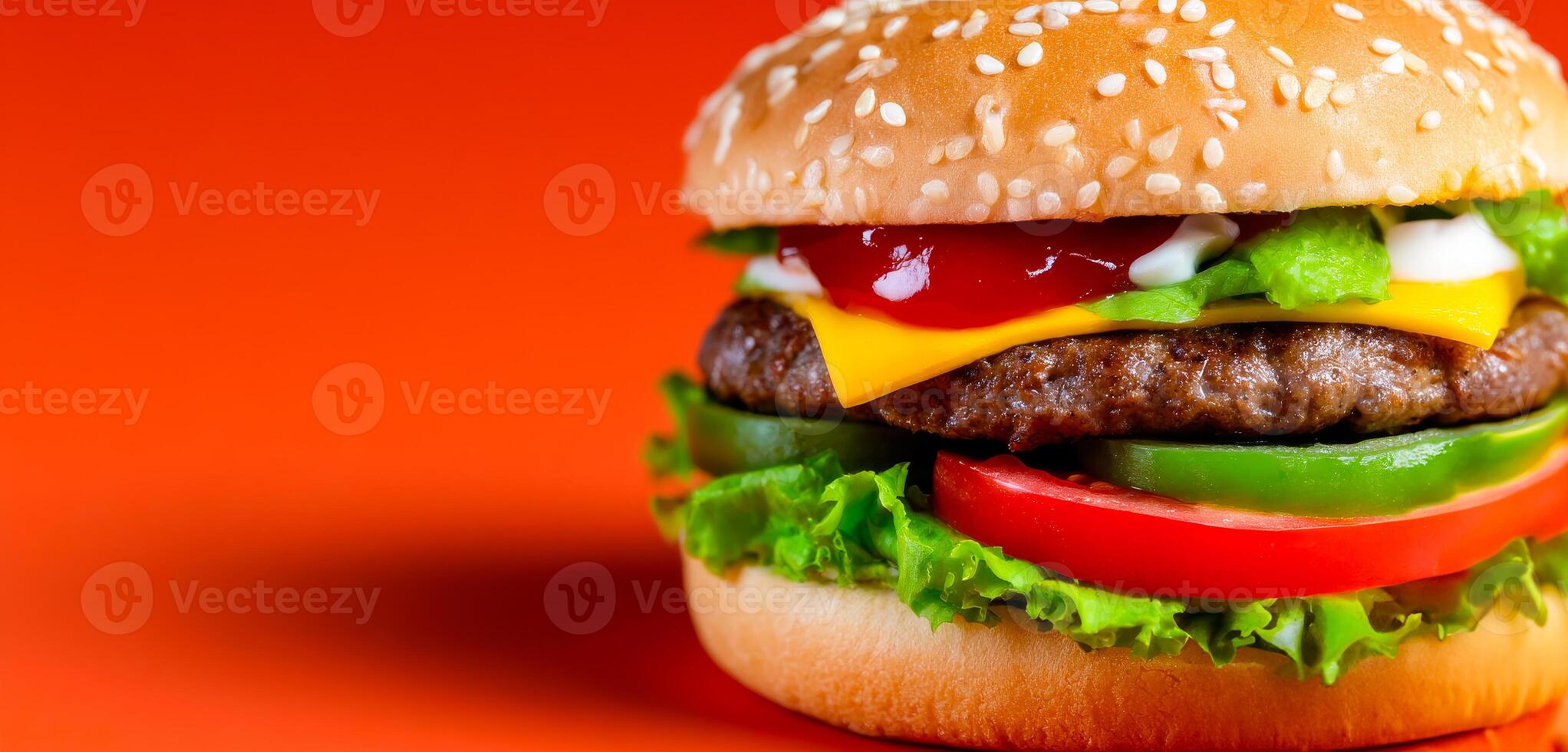 Delicious burger with fresh ingredients. A burger stacked with lettuce, tomato, cheese, and sauces against a vibrant orange background, evoking appetite. photo