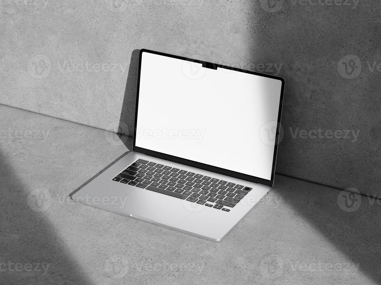 High-angle view of a laptop mockup placed on a textured cement surface, emphasizing simplicity and modernity. photo
