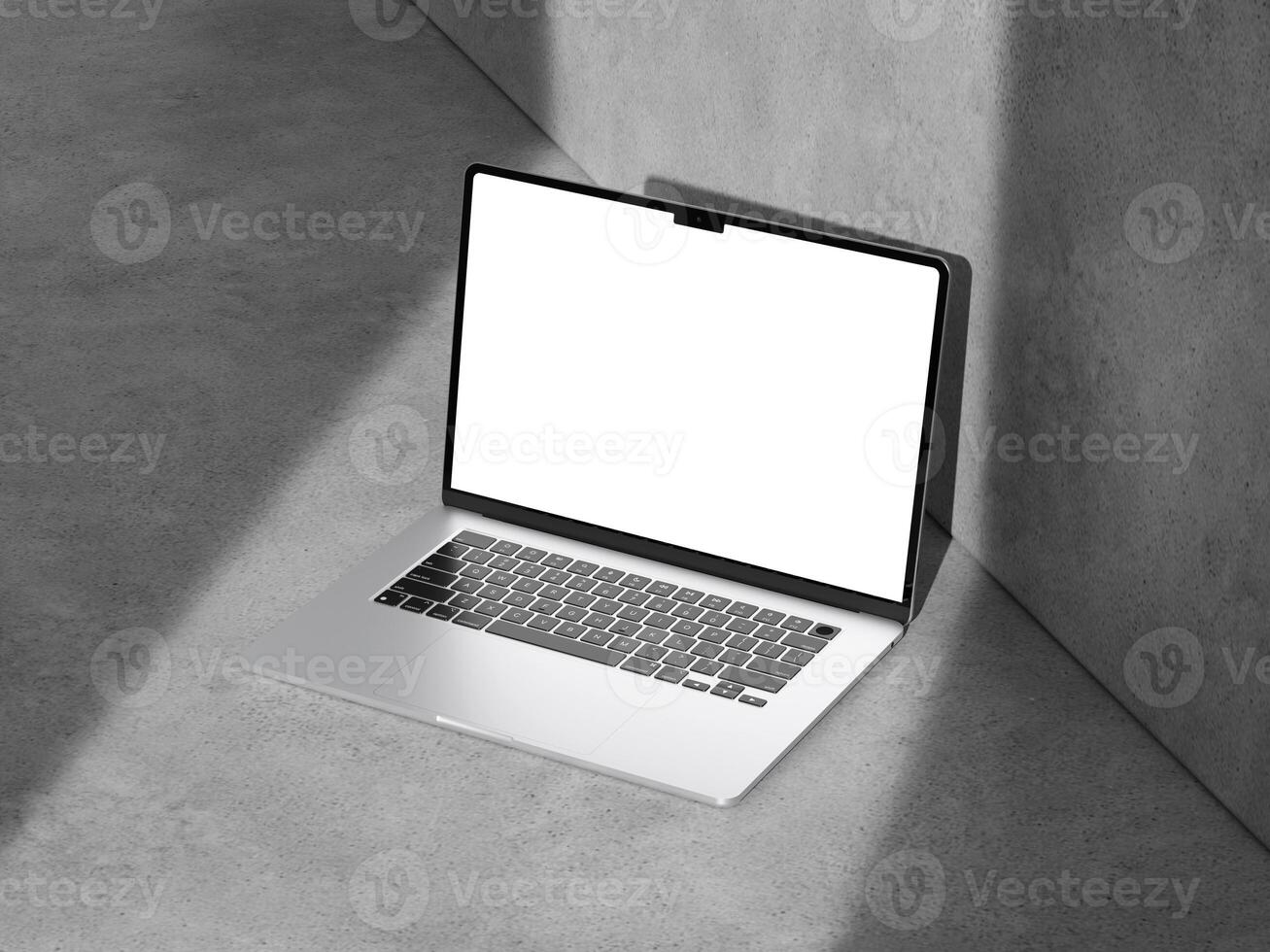 A well-lit laptop mockup on a cement surface, ideal for modern marketing and design projects. photo