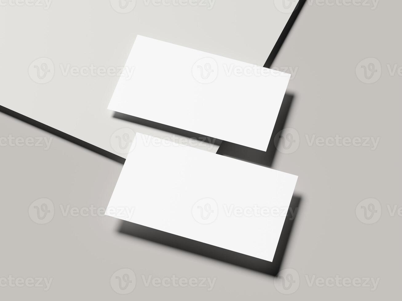 Angled pair of business cards with sharp shadow on light gray background photo