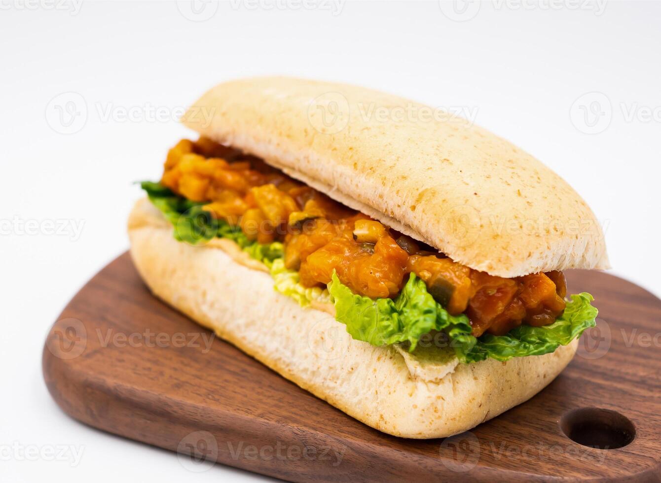 Ratatouille Vegetable and Lettuce Whole Wheat Ciabatta Sandwich on wooden board side view of vegan menus photo