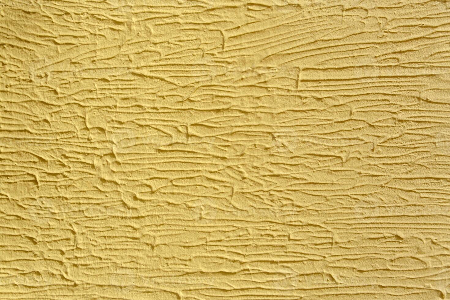 A wall with a white paint that has a texture. The texture is made up of lines. photo