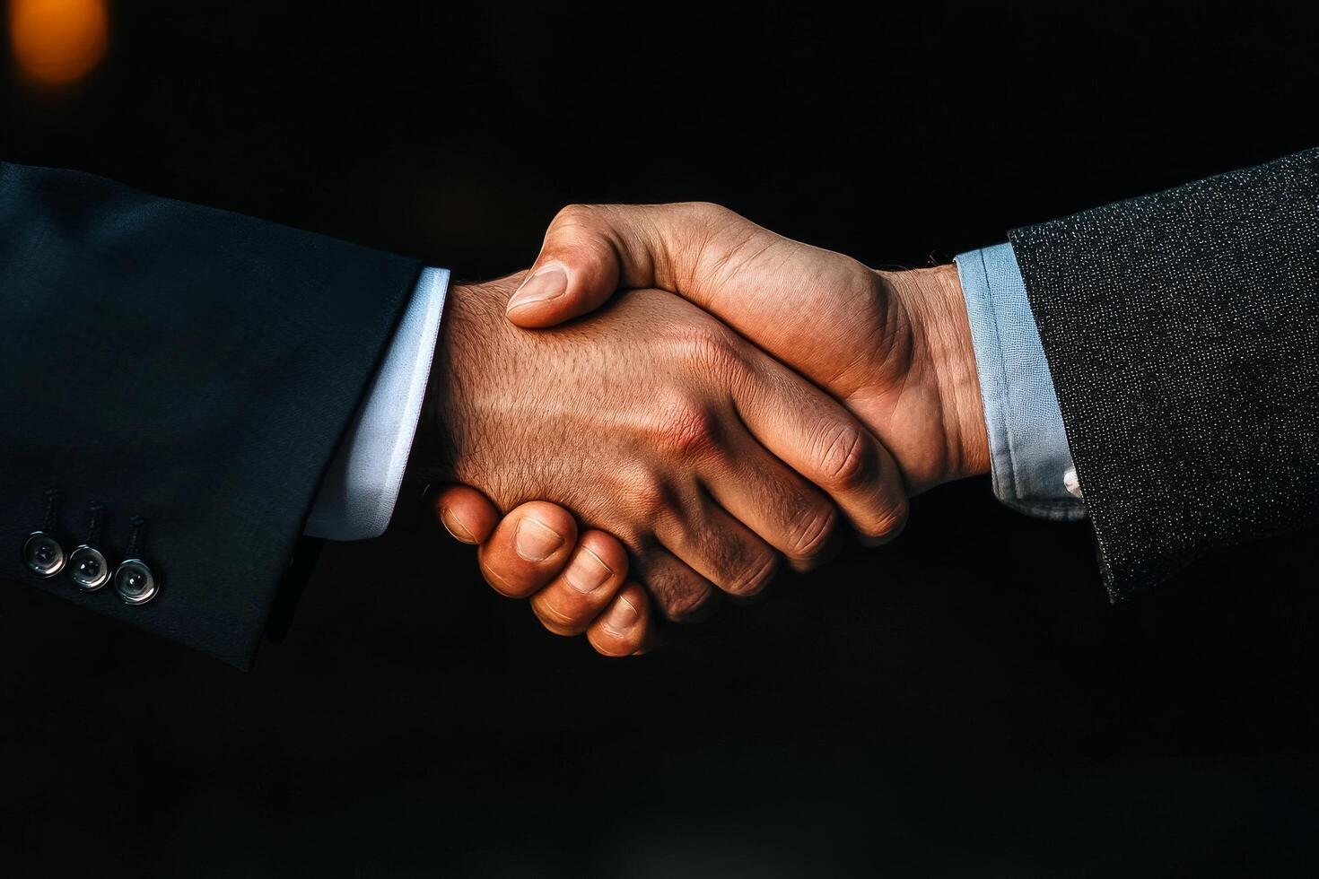 Handshake Between Two Business Professionals During a Formal Meeting in a Dimly Lit Office photo
