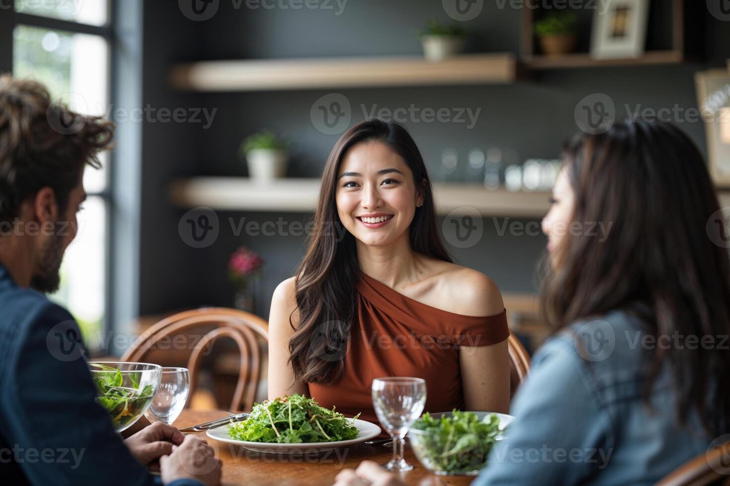 Three People Dining with Salad Bowls photo