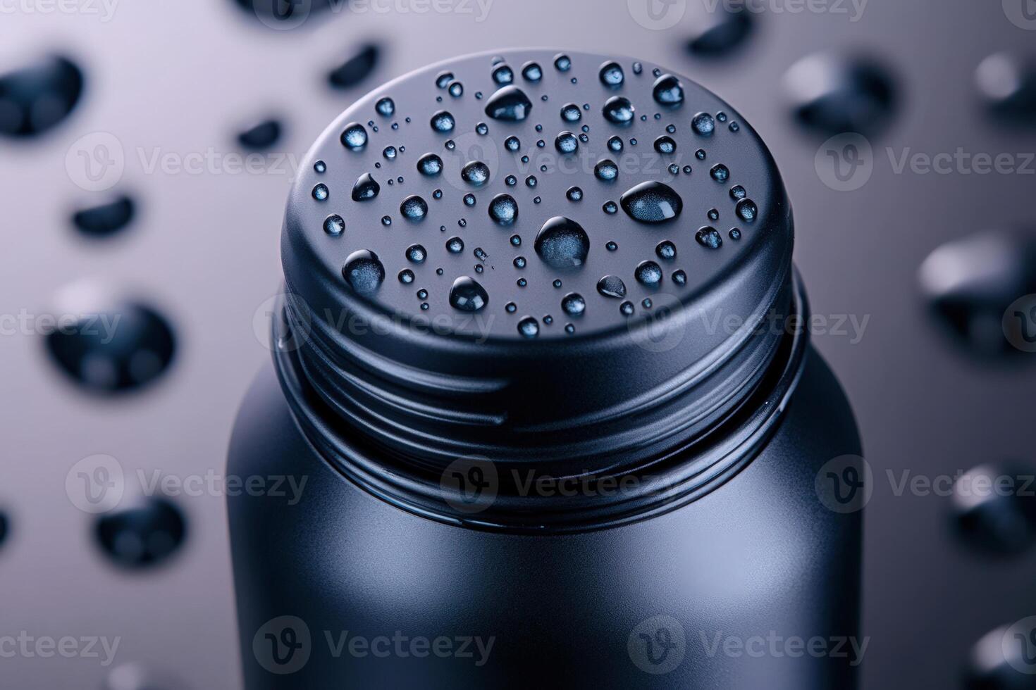 Close up of black water bottle covered with condensation on dark wet surface photo