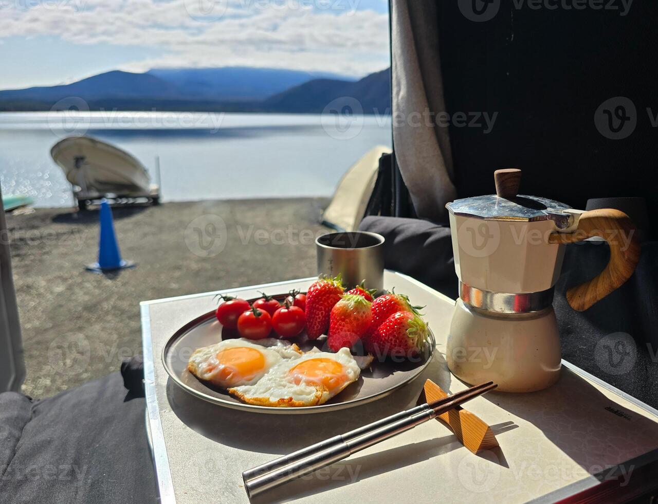 Landscape photography from tent with breakfast food, strewberry, egg, tomato, coffee photo