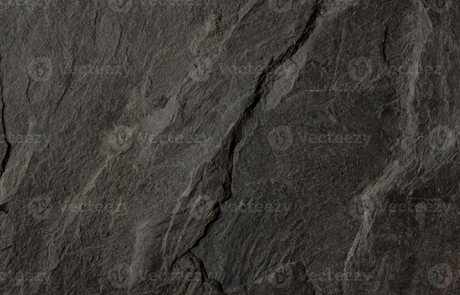 Natural dark slate stone texture with rough, layered surface ideal for backgrounds or design use photo