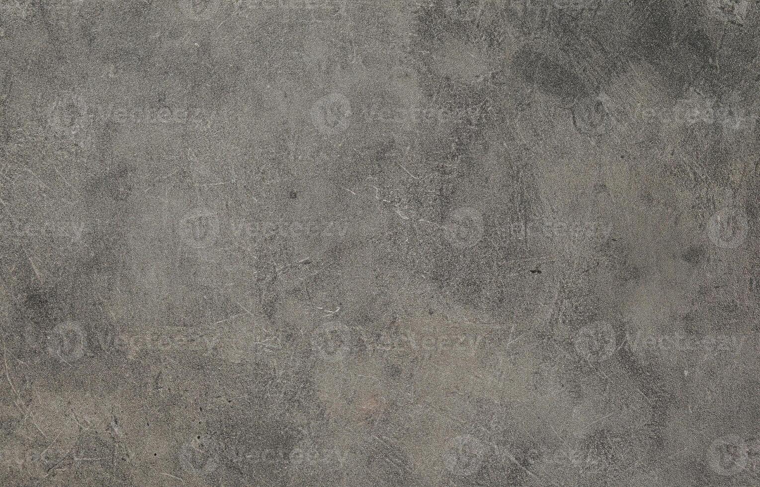 Rough dark gray concrete surface with subtle scratches and grunge texture, ideal for backgrounds or overlays. photo