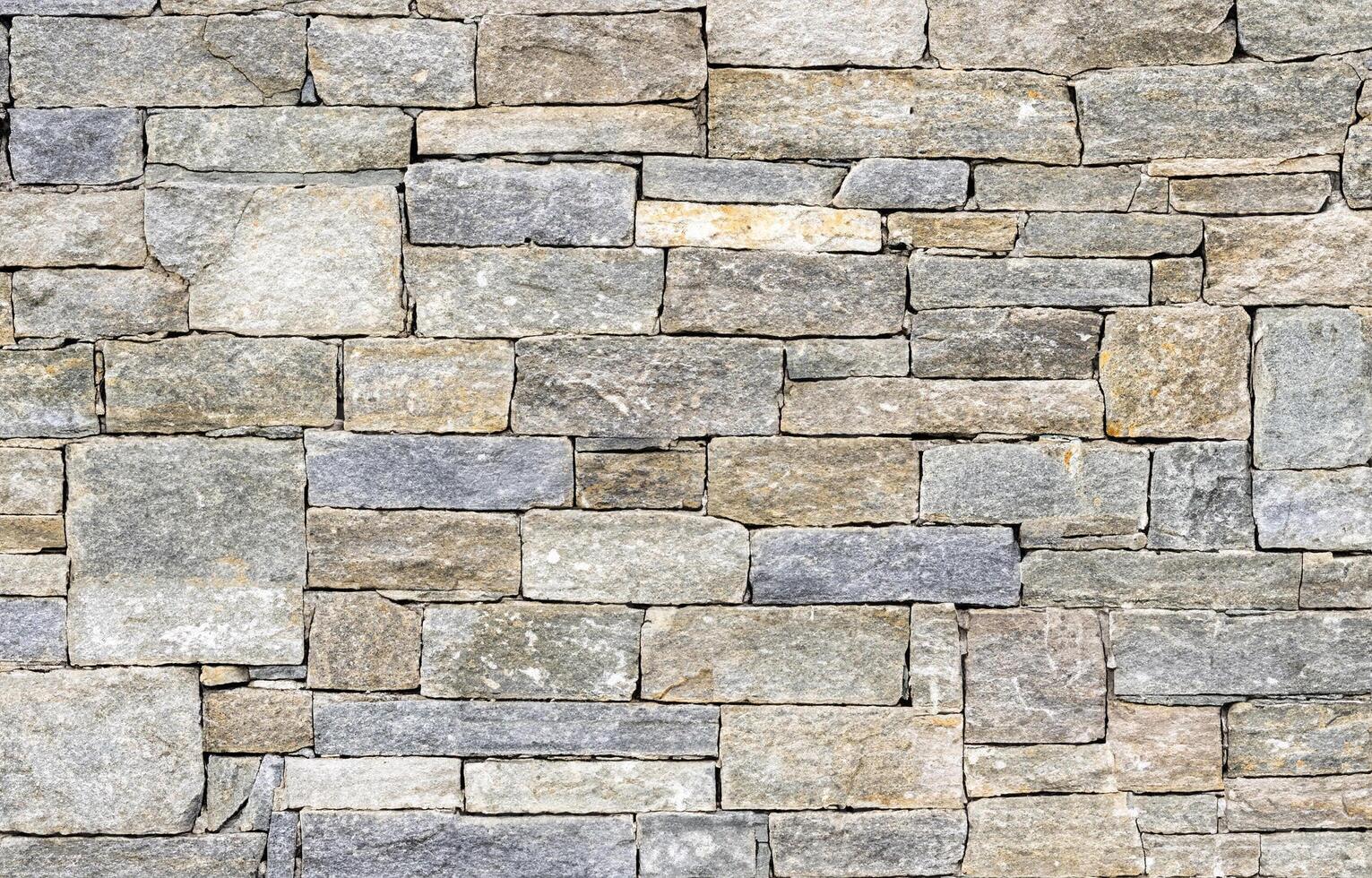 Seamless natural stone wall texture with mixed gray and beige tones, ideal for backgrounds and design projects photo