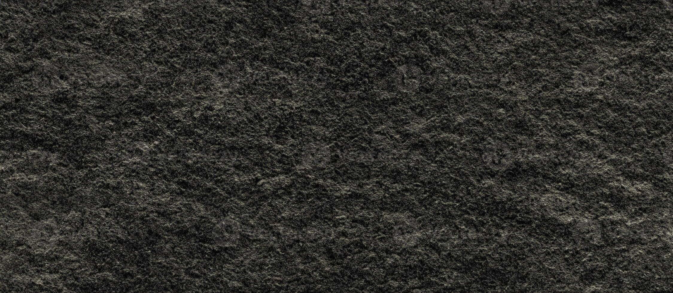 Seamless rough stone texture with dark tones, ideal for backgrounds, walls, and architectural design. photo