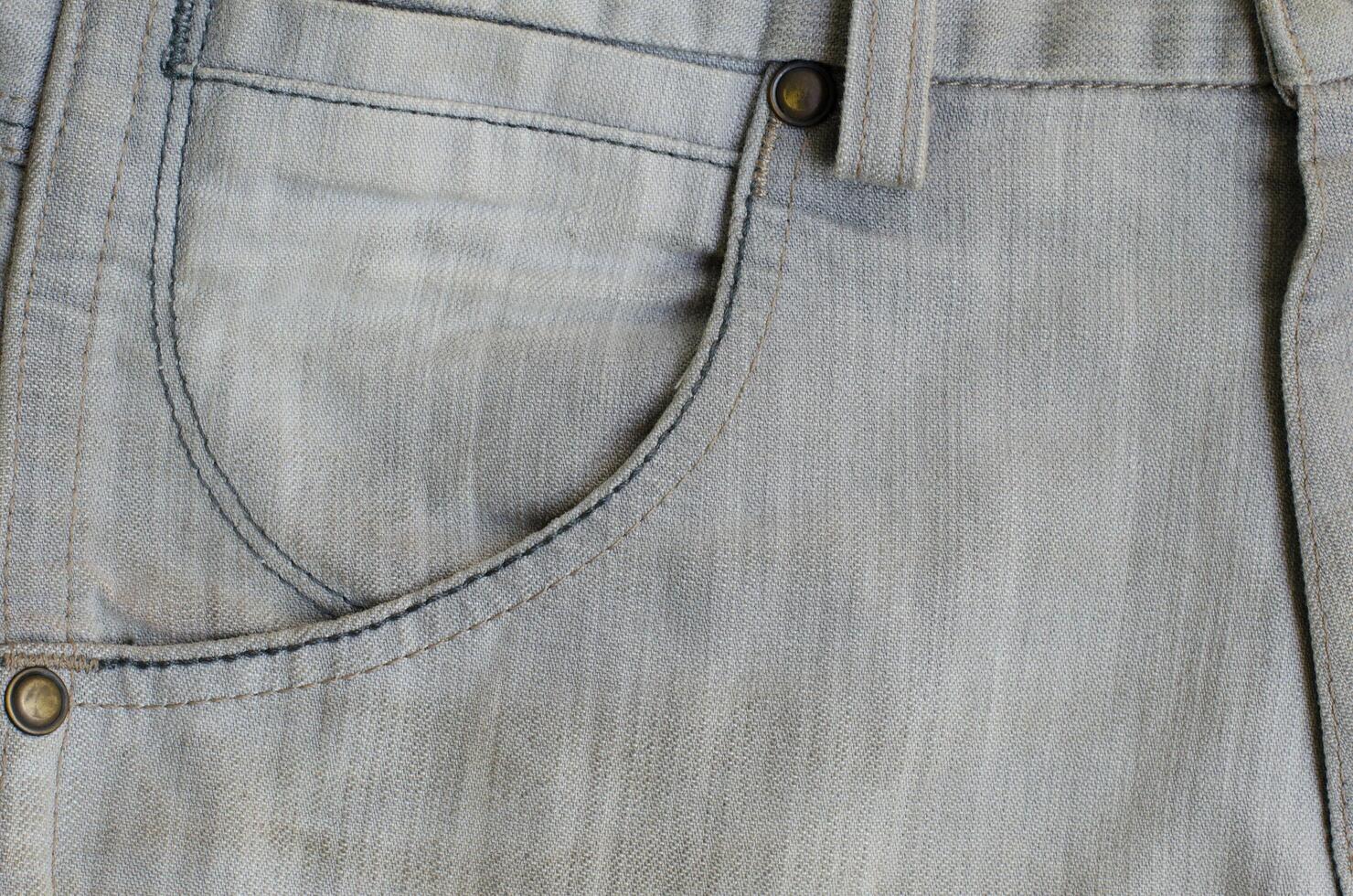 Texture of Gray Denim Jeans with Part of Trousers photo