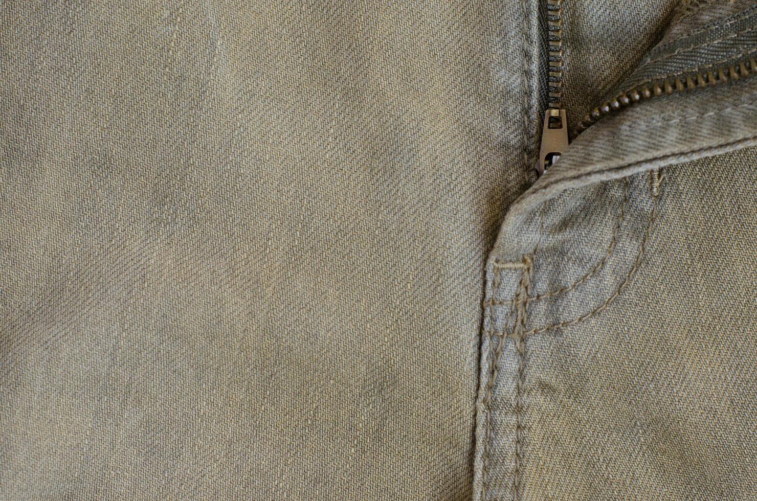 Texture of Brown Denim Jeans with Part of Trousers photo