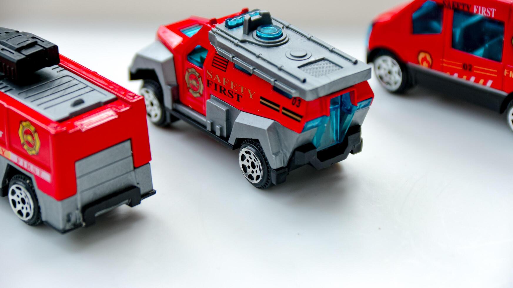 Toy Fire Trucks Grouped Together on White Surface for Kids Play photo