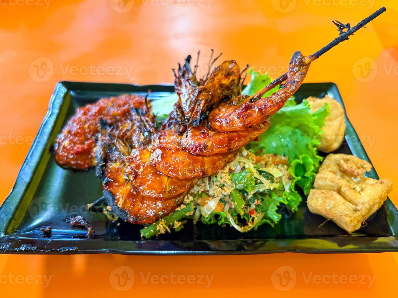 Grilled Prawns Served with Vegetables, Chili Sauce, and Fried Tofu photo