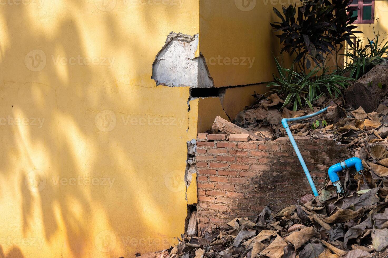 Cropped shot view of cracked building. Wider cracks often represent serious structural damage and can cause serious issues. photo