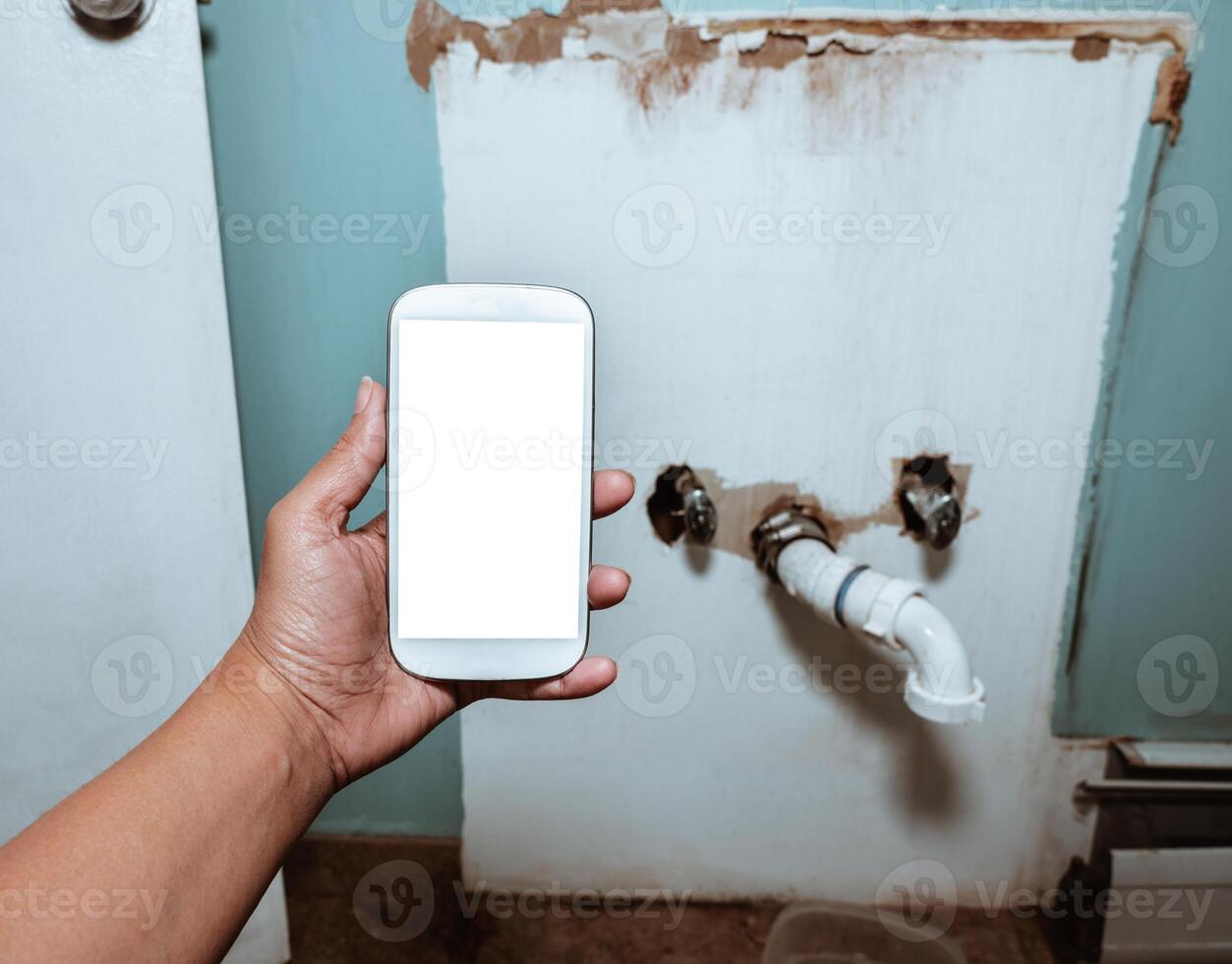 Plumbing smartphone app mock-up with copy space, plumbing maintenance and repair service concept. photo