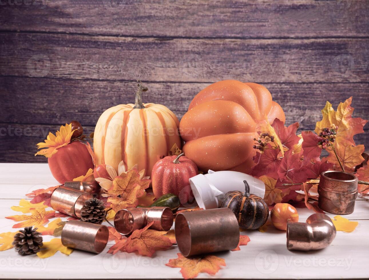 Happy Thanksgiving with construction tools, leaves and pumpkin on wood background. photo