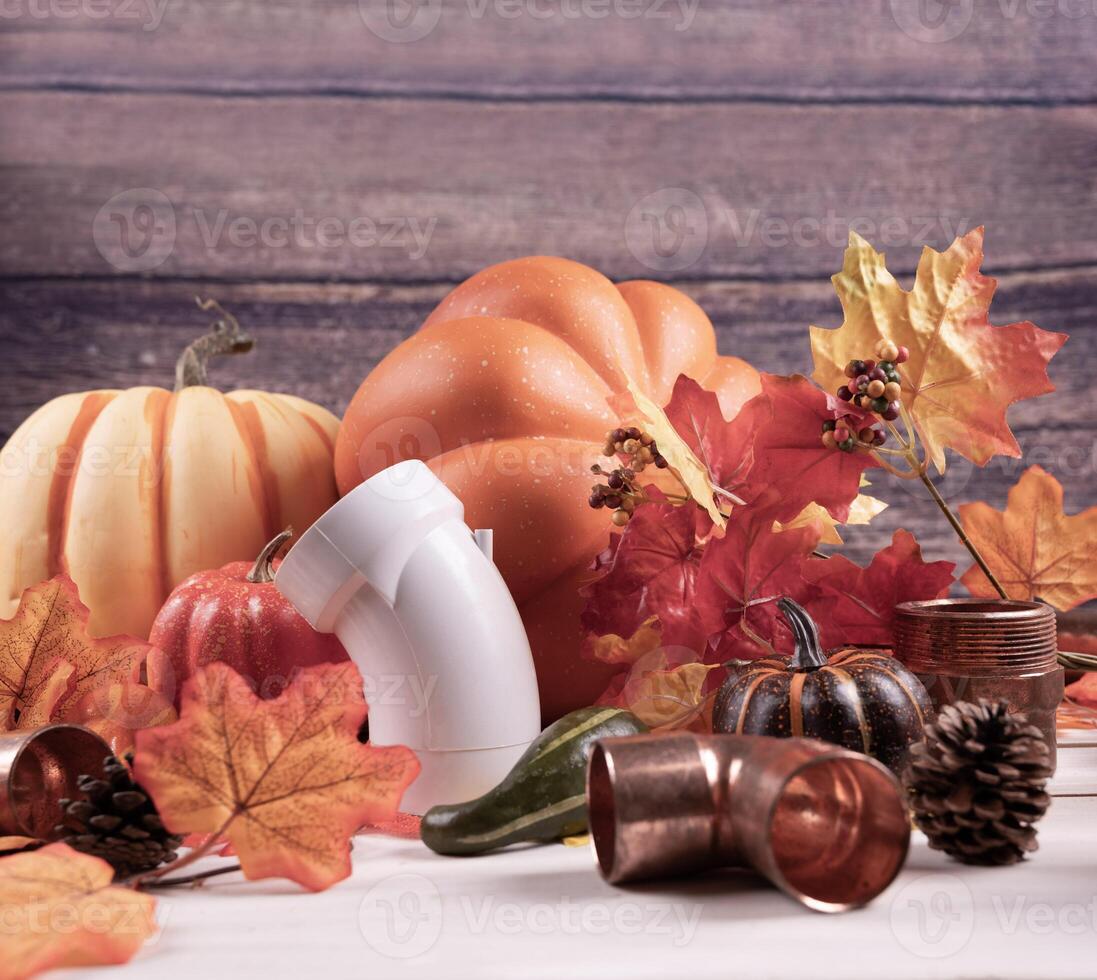 Happy Thanksgiving with construction tools, maple leaves and pumpkin on wood background. Autumn composition with copy space. photo