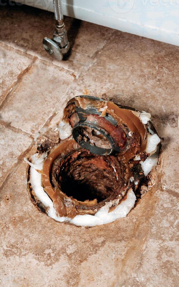 Vertical macro shot of wax ring seated on toilet flange photo