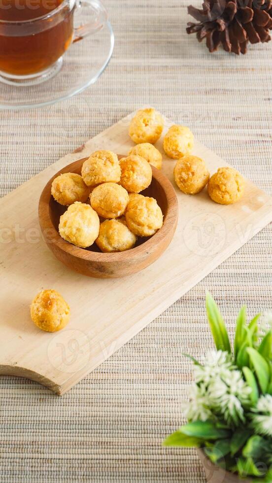 Cheese puffs on a wooden plate photo