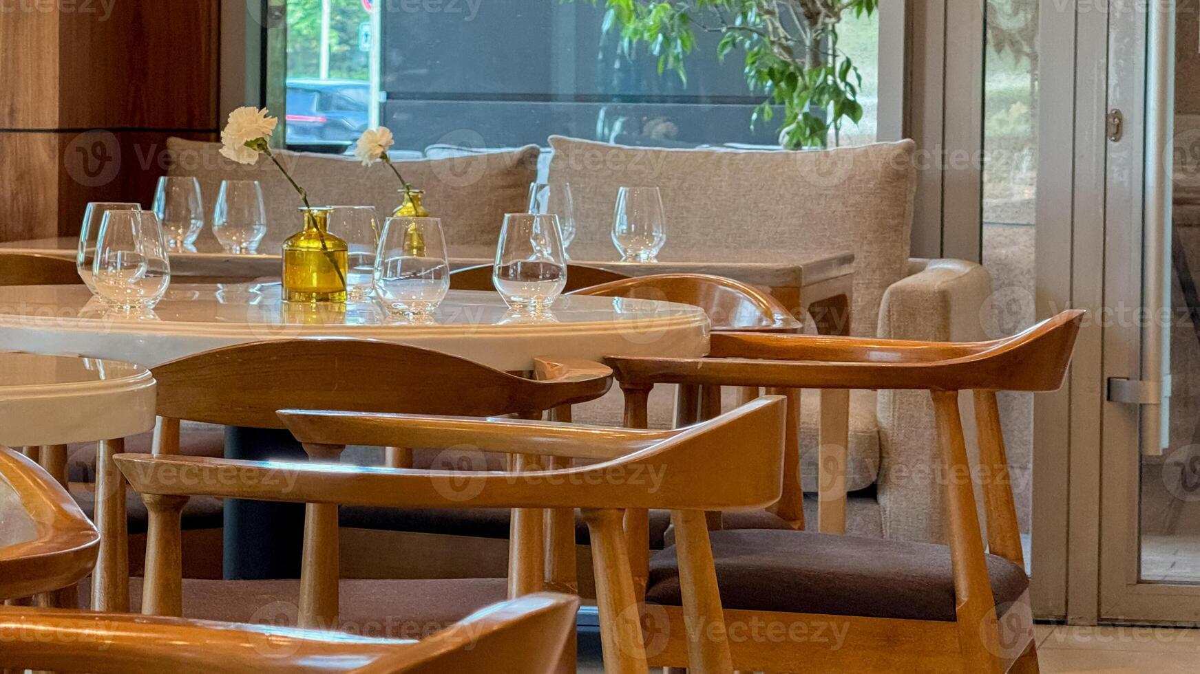Elegant minimalist dining setting with wooden chairs, echoing Nordic simplicity, perfect for Hygge gatherings and Slow Food Movement celebrations photo
